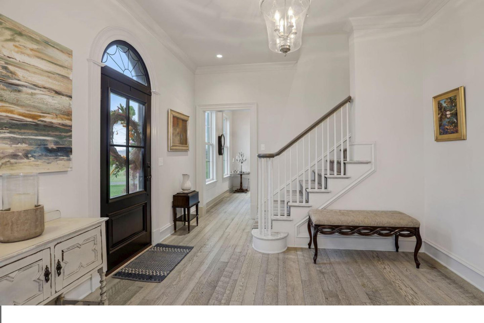 Inspiration for a mid-sized transitional light wood floor foyer remodel in DC Metro with gray walls and a black front door