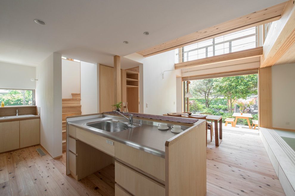 Photo of an asian open plan kitchen in Yokohama with light hardwood floors and beige floor.