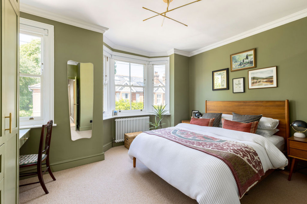 Large transitional master carpeted and beige floor bedroom photo in Hampshire with green walls