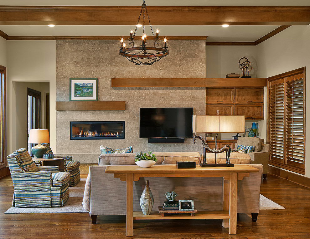 Photo of a mid-sized transitional family room in Dallas with beige walls, medium hardwood floors, a stone fireplace surround and a wall-mounted tv.