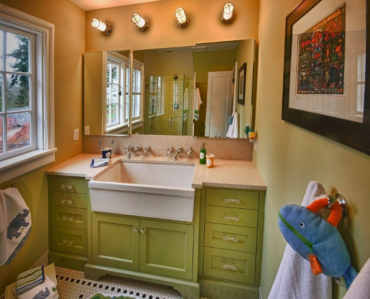 Photo of a mid-sized beach style kids bathroom in Portland with shaker cabinets and green cabinets.