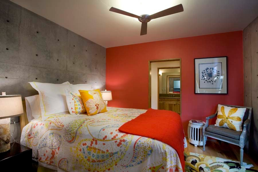 Photo of a mid-sized industrial guest bedroom in Salt Lake City with red walls, no fireplace, brown floor and medium hardwood floors.