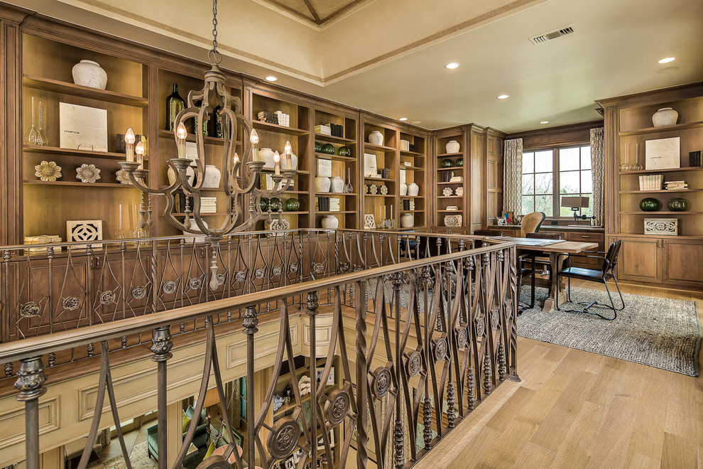 This is an example of a mediterranean home office in Dallas with medium hardwood floors.