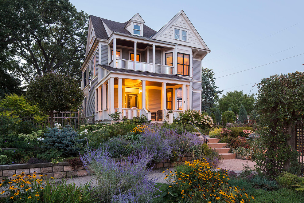 Design ideas for an arts and crafts two-storey blue exterior in Minneapolis with wood siding.