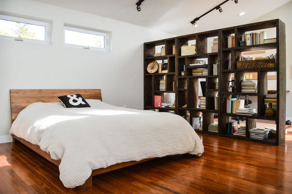 Design ideas for a contemporary bedroom in Denver with white walls and medium hardwood floors.