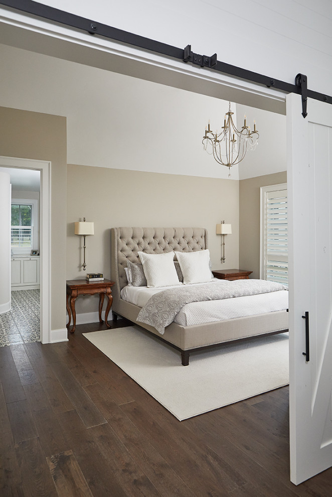 Photo of a large traditional master bedroom in Grand Rapids with beige walls and medium hardwood floors.