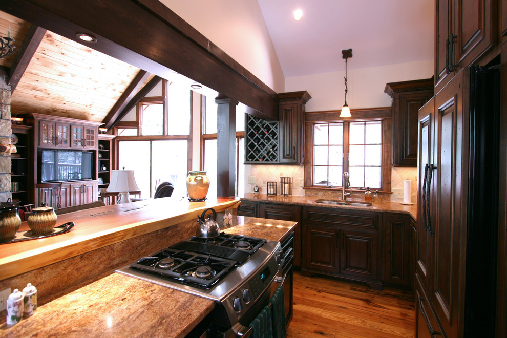 Photo of a mid-sized country galley eat-in kitchen in Charlotte with an undermount sink, medium wood cabinets, granite benchtops, stainless steel appliances and medium hardwood floors.