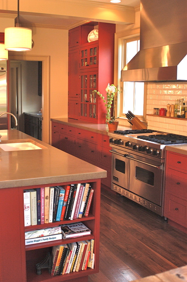 Design ideas for a large traditional single-wall separate kitchen in Denver with an undermount sink, shaker cabinets, red cabinets, concrete benchtops, white splashback, subway tile splashback, stainless steel appliances, dark hardwood floors, with island and brown floor.