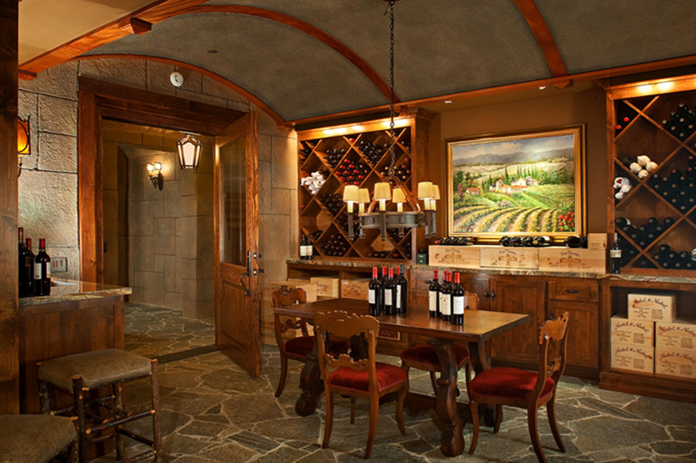 Photo of a large arts and crafts wine cellar in San Diego with slate floors, display racks and grey floor.