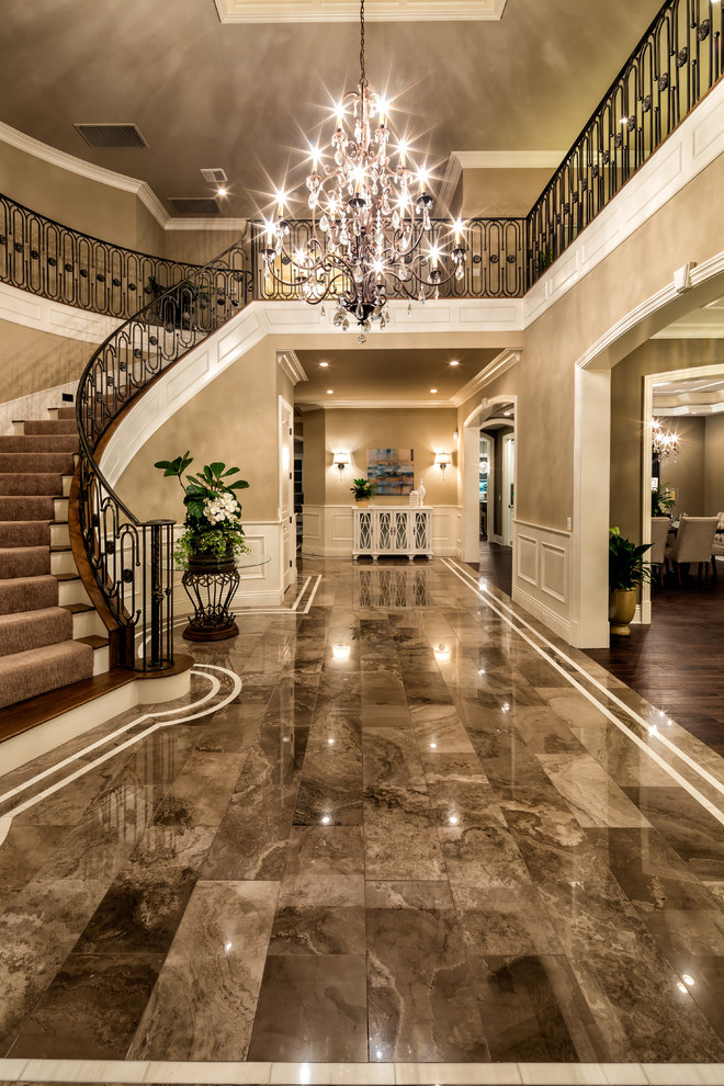 Transitional entryway in Los Angeles with marble floors.