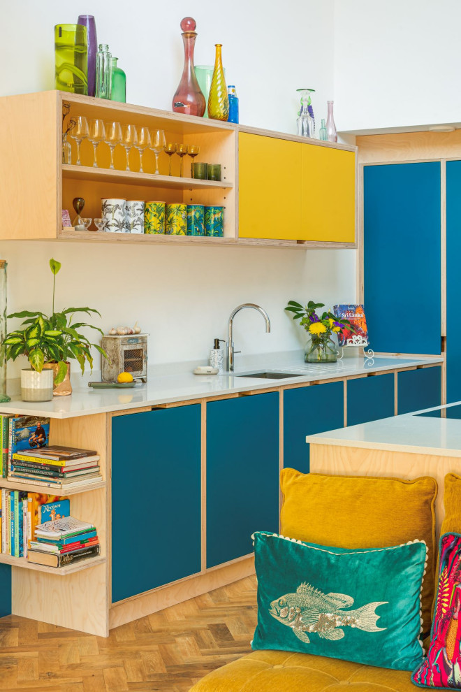 Photo of a large modern l-shaped breakfast bar in Other with open cabinets and blue cabinets.