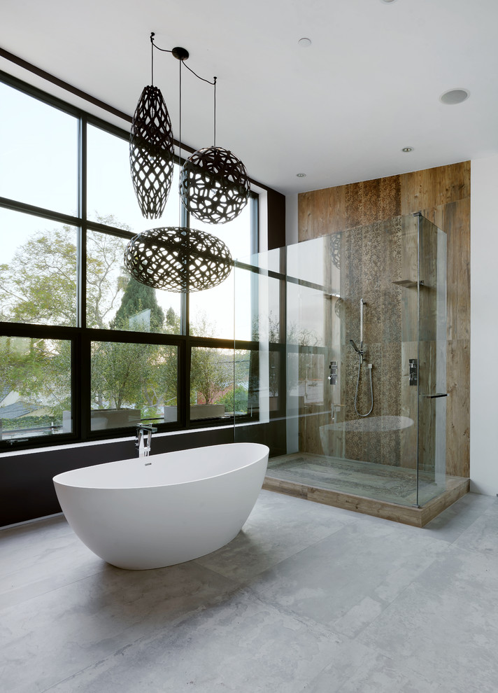 Inspiration for a large contemporary master bathroom in Los Angeles with a freestanding tub, brown tile, concrete floors and a double shower.