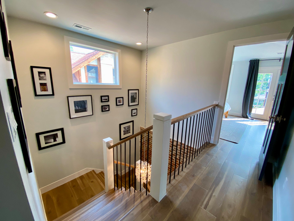 Staircase - large transitional wooden u-shaped mixed material railing and brick wall staircase idea in Denver with wooden risers