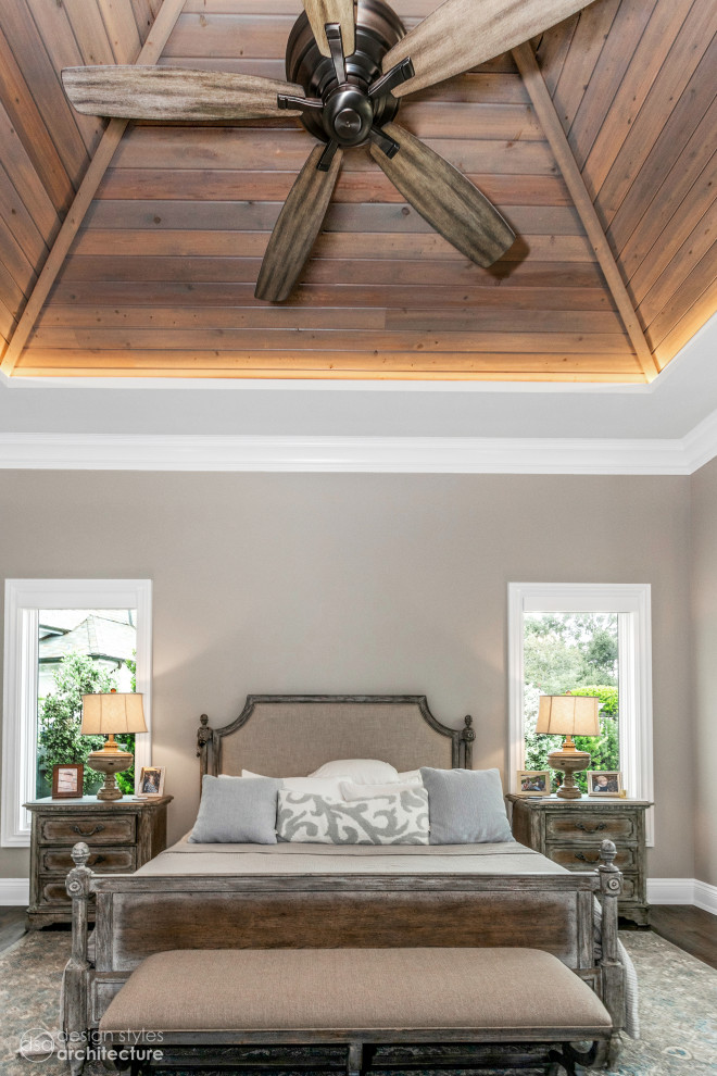 This is an example of a large master bedroom in Tampa with grey walls, marble flooring, beige floors and a wood ceiling.