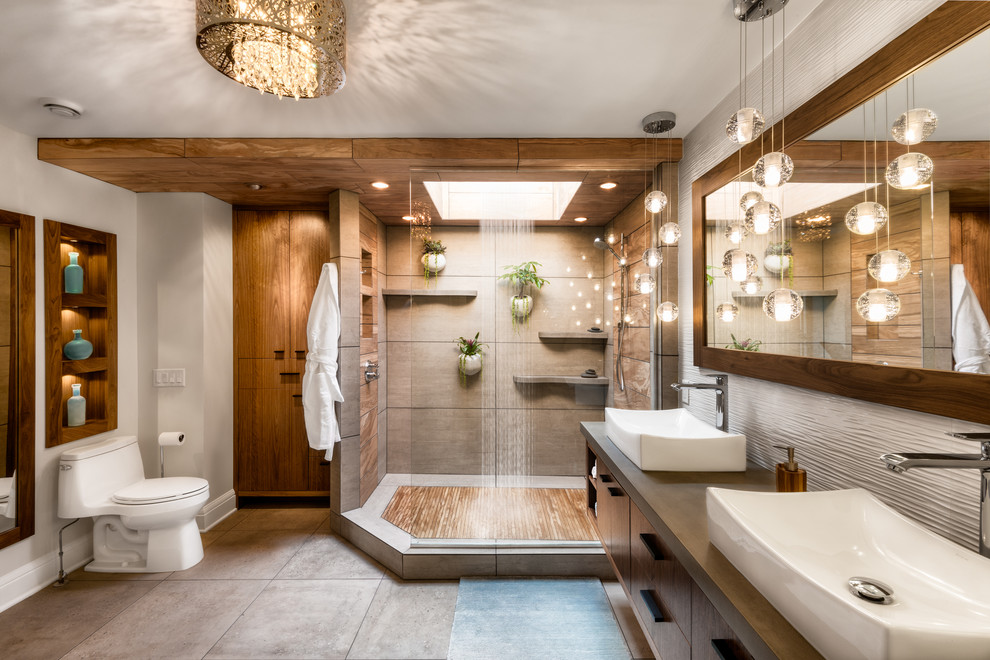 Photo of a large tropical master bathroom in Minneapolis with flat-panel cabinets, dark wood cabinets, a corner shower, a one-piece toilet, white walls, a vessel sink, grey floor, an open shower, gray tile, ceramic tile, ceramic floors and concrete benchtops.