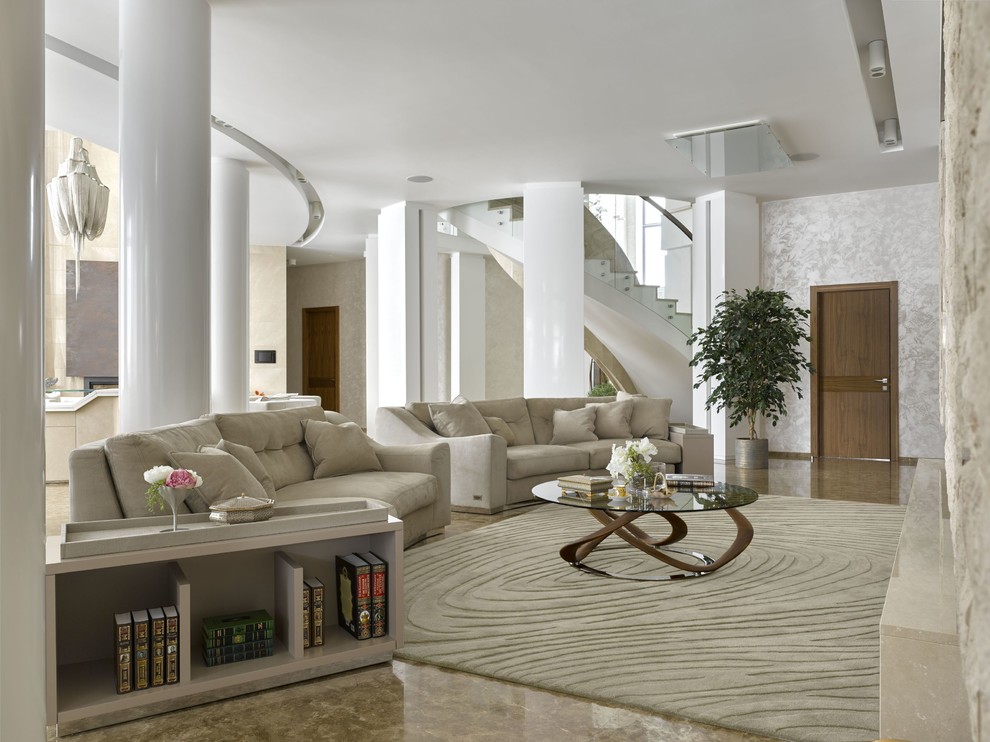This is an example of an expansive contemporary open concept living room in Moscow with white walls, marble floors and a freestanding tv.