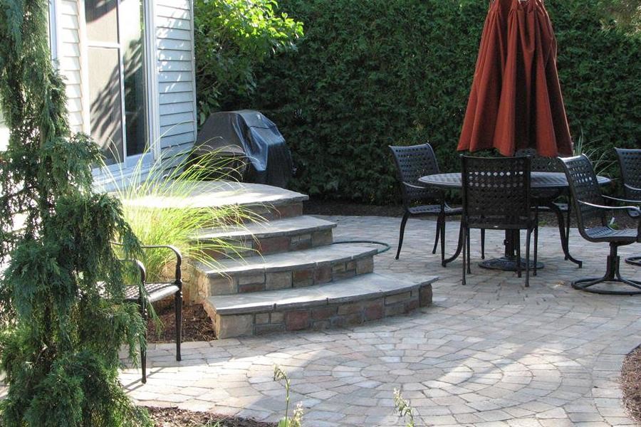 This is an example of a mid-sized traditional backyard patio in Toronto with natural stone pavers and no cover.
