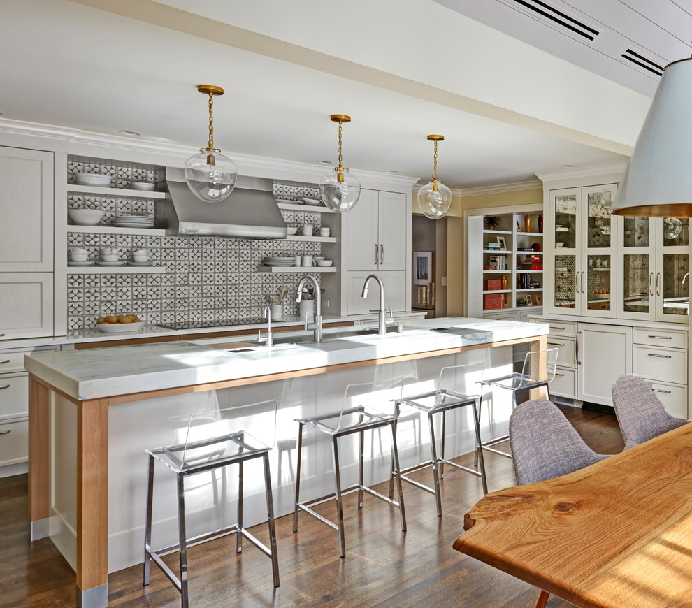Design ideas for a large transitional galley eat-in kitchen in Chicago with an undermount sink, shaker cabinets, white cabinets, marble benchtops, porcelain splashback, panelled appliances, with island, multi-coloured splashback, dark hardwood floors and brown floor.