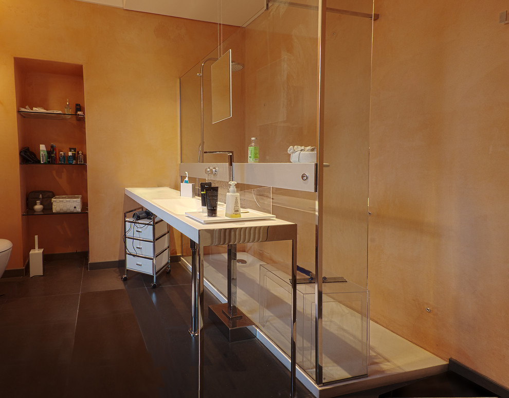 Mid-sized contemporary 3/4 bathroom in Turin with open cabinets, a console sink, white cabinets, an open shower, a wall-mount toilet, orange tile, white walls, porcelain floors and quartzite benchtops.