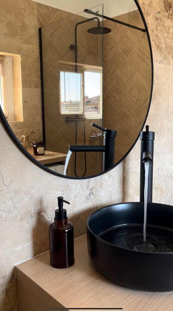 Mid-sized minimalist beige tile and stone slab travertine floor and beige floor powder room photo in Nice with a wall-mount toilet, beige walls and a drop-in sink