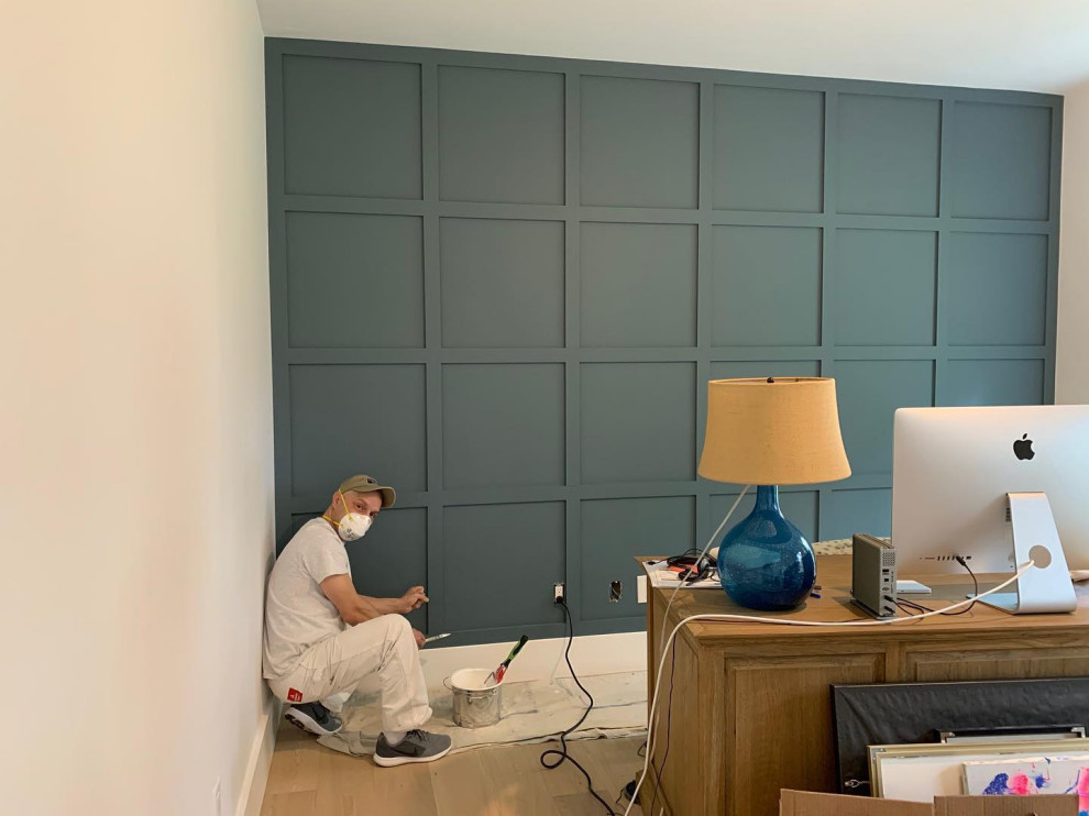 トロントにある高級な中くらいなコンテンポラリースタイルのおしゃれな書斎 (青い壁、ラミネートの床、暖炉なし、自立型机、茶色い床、パネル壁) の写真