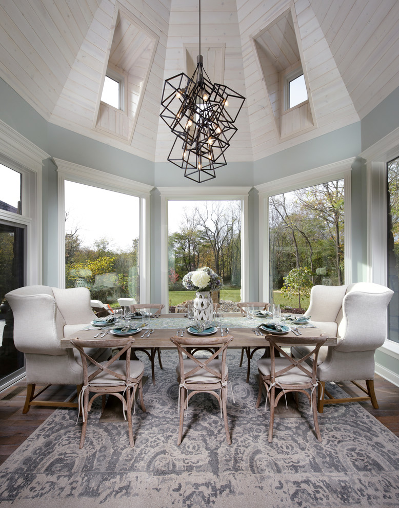 Country dining room in Other with blue walls, dark hardwood floors and no fireplace.