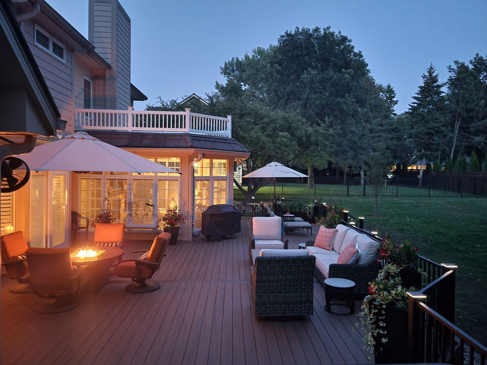 Inspiration for a large timeless backyard ground level metal railing deck remodel in Other with no cover