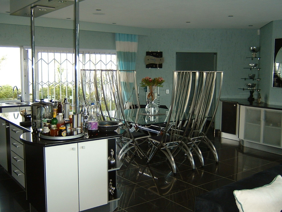 This is an example of a contemporary kitchen/dining combo in Other with blue walls and porcelain floors.
