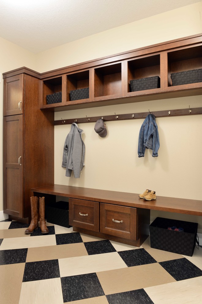 This is an example of a large arts and crafts mudroom in Other with beige walls and linoleum floors.