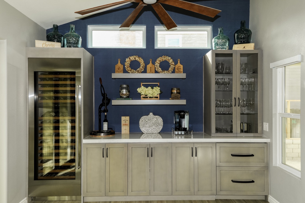 This is an example of a mid-sized traditional single-wall wet bar in Orange County with shaker cabinets, light wood cabinets and quartz benchtops.