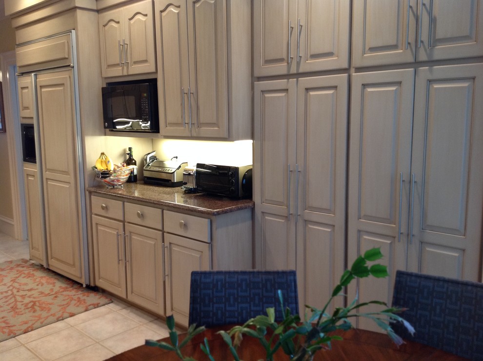 Open concept kitchen - large transitional open concept kitchen idea with raised-panel cabinets, beige cabinets, granite countertops and an island