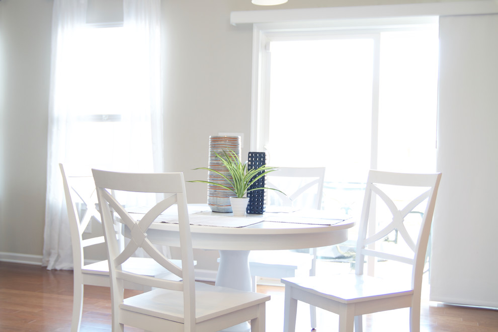 Inspiration for a mid-sized transitional medium tone wood floor and brown floor dining room remodel with white walls and no fireplace