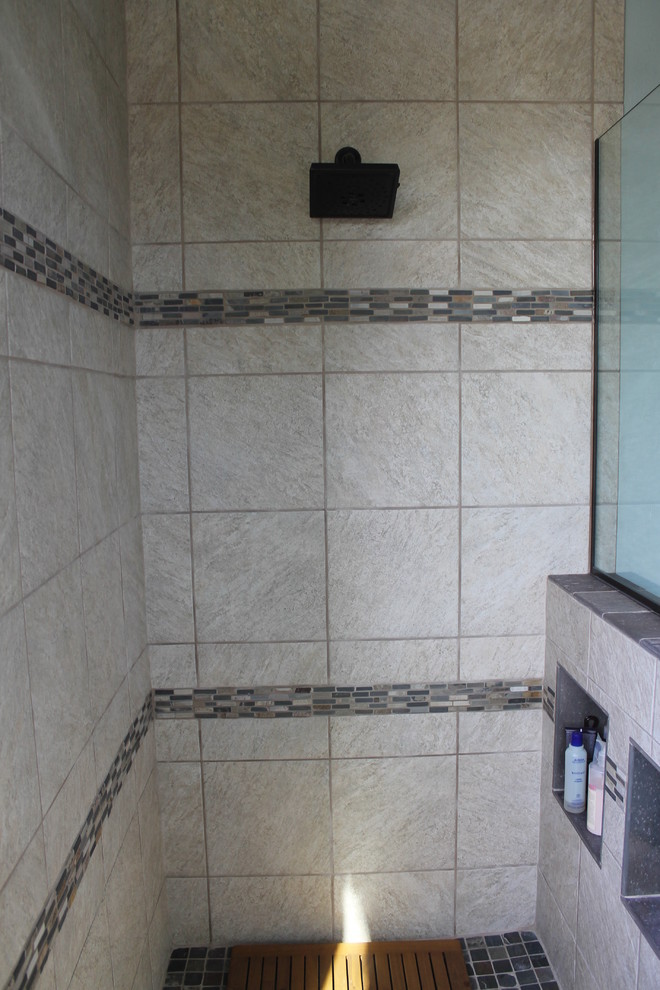 Mid-sized transitional master beige tile and porcelain tile porcelain tile and brown floor walk-in shower photo in Phoenix with flat-panel cabinets, black cabinets, a two-piece toilet, blue walls, an undermount sink and quartz countertops