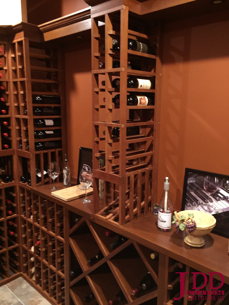 Mid-sized traditional wine cellar in Cincinnati with porcelain floors and storage racks.
