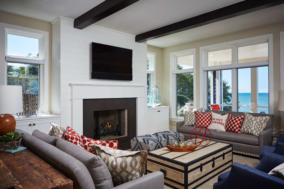 Design ideas for a beach style family room in Grand Rapids with white walls, a standard fireplace and a wall-mounted tv.