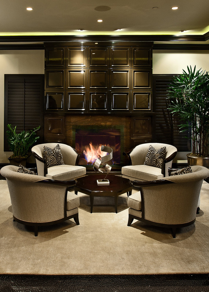 This is an example of a mid-sized transitional formal living room in Orange County with a standard fireplace, beige walls and dark hardwood floors.