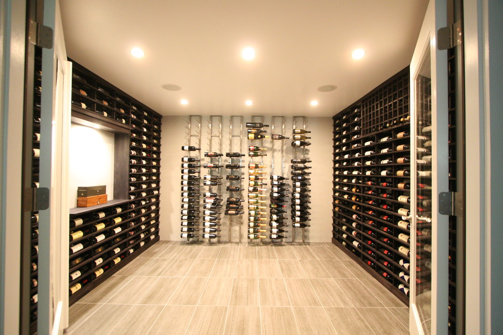 This is an example of an expansive modern wine cellar in New York with porcelain floors, display racks and brown floor.