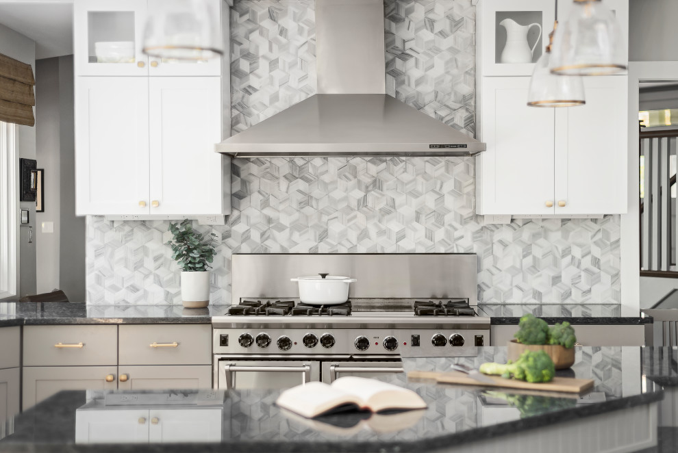 Large transitional medium tone wood floor open concept kitchen photo in Chicago with an undermount sink, shaker cabinets, white cabinets, granite countertops, gray backsplash, marble backsplash, stainless steel appliances, an island and black countertops