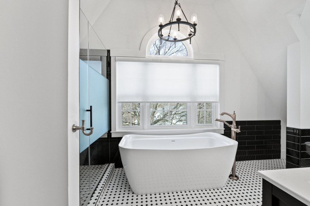 Design ideas for a medium sized bohemian ensuite bathroom in Kansas City with raised-panel cabinets, black cabinets, a freestanding bath, an alcove shower, a one-piece toilet, black tiles, ceramic tiles, white walls, ceramic flooring, a submerged sink, engineered stone worktops, white floors, a hinged door, white worktops, a wall niche, double sinks, a freestanding vanity unit, a vaulted ceiling and wallpapered walls.