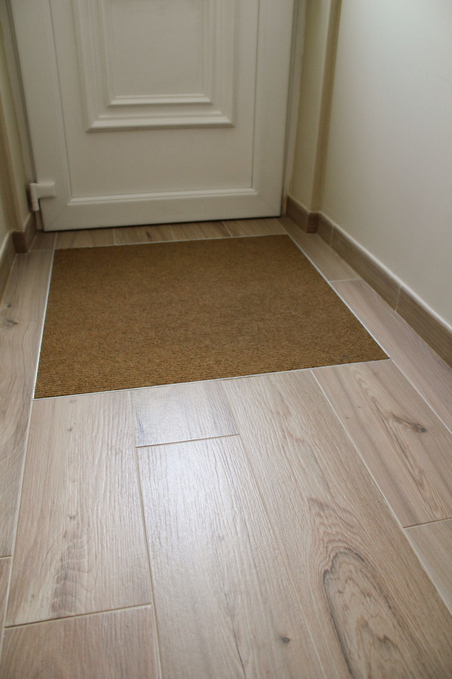 Small contemporary foyer in Other with ceramic flooring, a single front door, a white front door and beige walls.