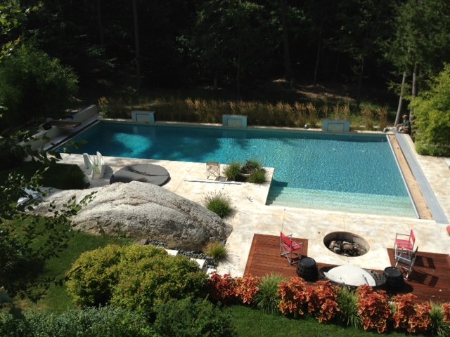 Photo of a large traditional backyard l-shaped lap pool in Boston with tile.