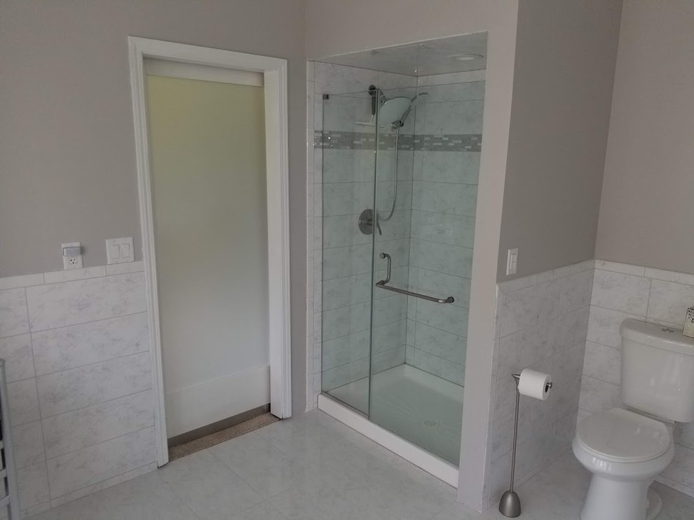 Mid-sized contemporary master bathroom in Chicago with recessed-panel cabinets, white cabinets, a freestanding tub, an alcove shower, a two-piece toilet, white tile, marble, grey walls, marble floors, an undermount sink, marble benchtops, white floor, a hinged shower door and white benchtops.