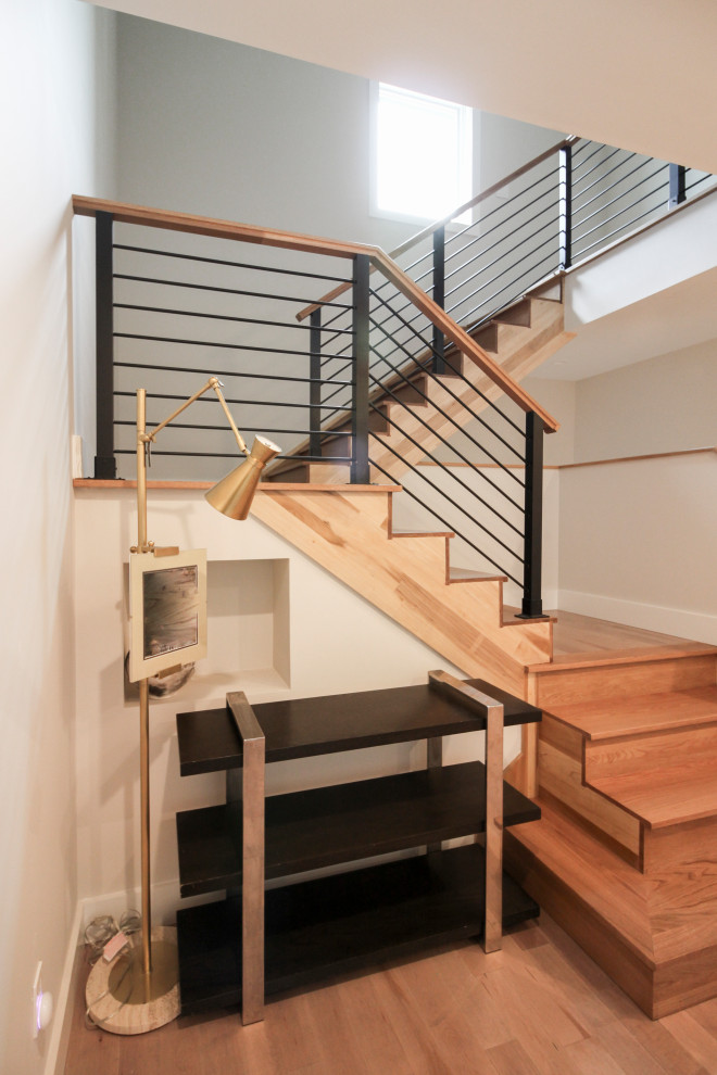 Inspiration for a large modern wood straight staircase in DC Metro with wood risers and mixed railing.