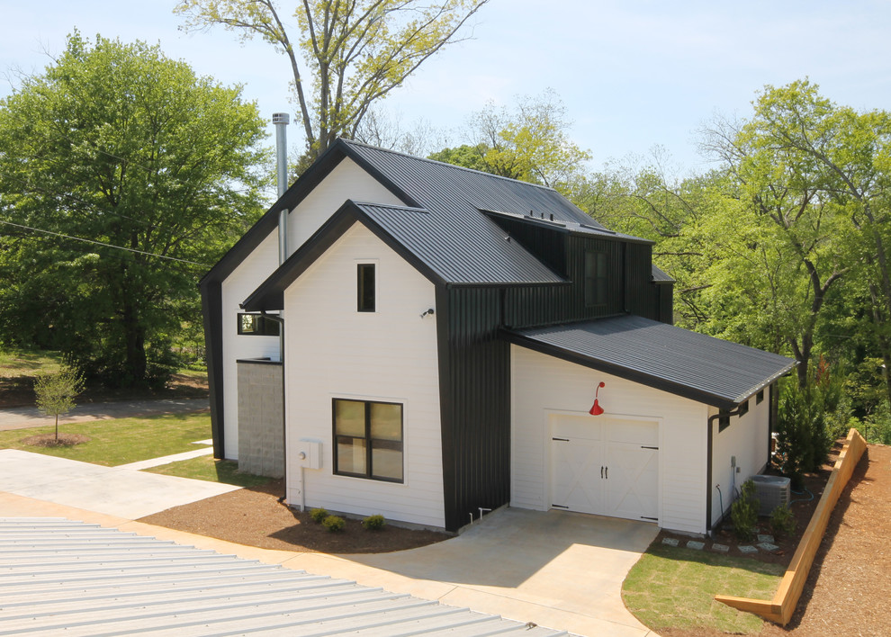 This is an example of a small modern two-storey white exterior in Atlanta with mixed siding.