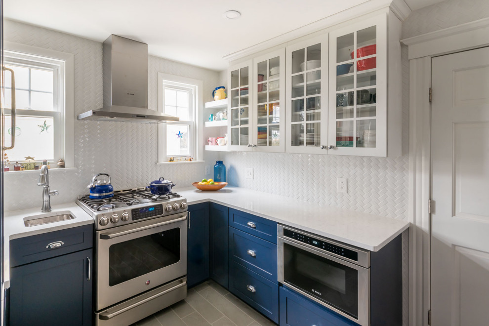 Example of a mid-sized transitional u-shaped porcelain tile and gray floor eat-in kitchen design in Boston with an undermount sink, shaker cabinets, blue cabinets, quartz countertops, white backsplash, subway tile backsplash, stainless steel appliances, a peninsula and white countertops