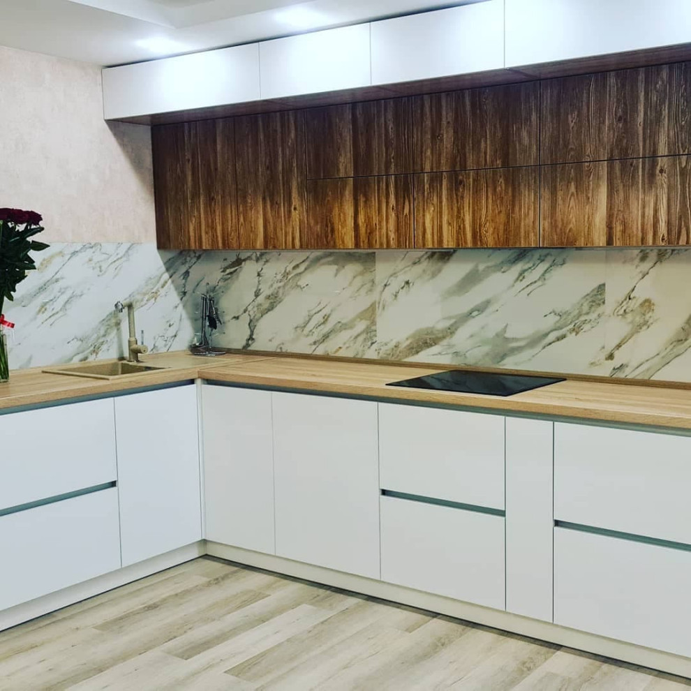 Inspiration for a medium sized modern l-shaped kitchen/diner in Moscow with a built-in sink, raised-panel cabinets, white cabinets, wood worktops, white splashback, granite splashback, integrated appliances, lino flooring, no island, beige floors and brown worktops.