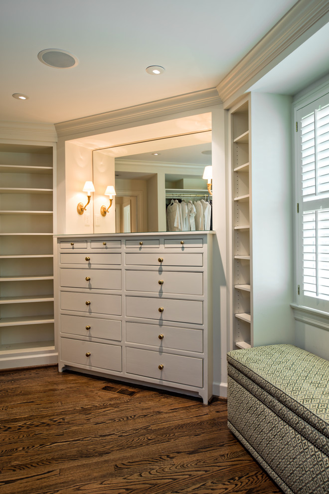 Inspiration for a large transitional gender-neutral dressing room in Nashville with flat-panel cabinets, white cabinets and medium hardwood floors.