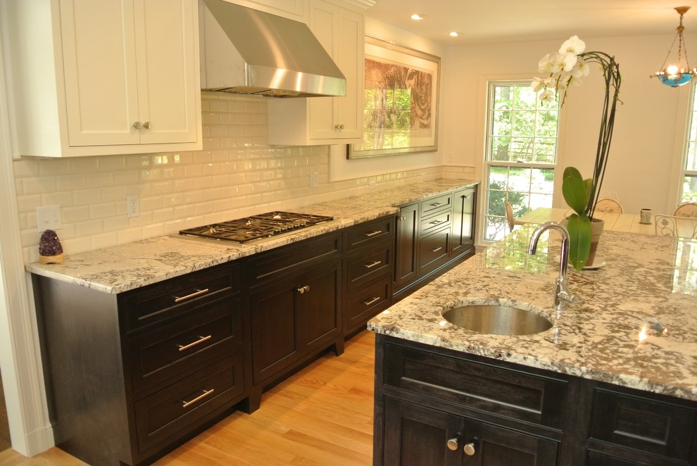 Eat-in kitchen - transitional light wood floor eat-in kitchen idea in Boston with an undermount sink, shaker cabinets, granite countertops, white backsplash, subway tile backsplash, stainless steel appliances and an island