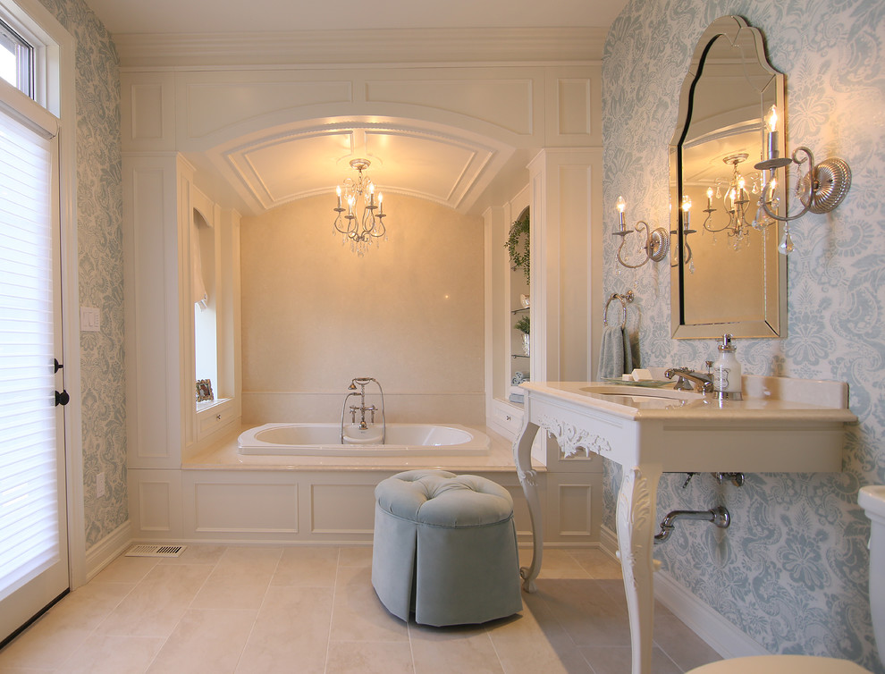 This is an example of a large traditional master bathroom in Toronto with a drop-in tub, beige tile, multi-coloured walls, a console sink, a two-piece toilet and ceramic floors.