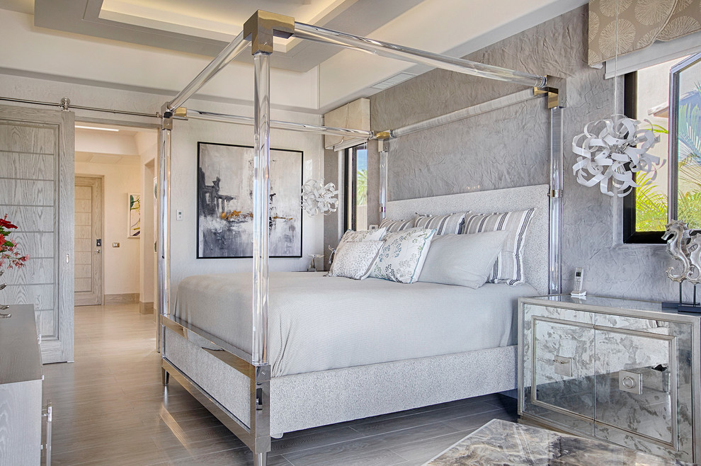 Photo of a mediterranean master bedroom in Other with grey walls, no fireplace and beige floor.